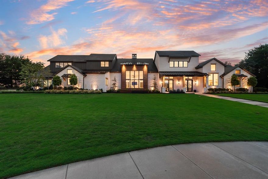 This stunning Hill Country Modern home is nestled within a private culdesac surrounded by lush green belts offering gorgeous sunset views.  This luxurious property offers a resort style custom pool and spa which features elegant water elements, sunning decks and firebowls, perfect for relaxing and entertaining.  The multiple outdoor living spaces include an outdoor grilling dining area and a cozy firepit, creating the ultimate retreat.  Inside you'll find an expansive open concept with natural hardwood flooring and decorative wood beams accentuated by designer lighting and ceiling fans throughout. The living room centers around a dramatic floor to ceiling marble clad fireplace that seamlessly flows into the chefs kitchen featuring a built-in referigerator and freezer, a 6 burner gas stove with griddle, warming drawer, microwave drawer, soft close cabinetry, custom pantry system and Butlers prep pantry.  The dining room showcases a built-in wine cellar wall with wine fridge.  The luxurious primary suite offers a vaulted exposed wood beam ceiling and a spa like bathroom with a standalone soaking tub, designer mirrors, a wall of custom linen and personal storage, His and Her custom closets and a hidden safe room.  The media and gameroom both offer hand crafted cabinetry with beverage fridge.  The well appointed laundry room features beautiful cabinetry for upper and lower storage,  folding counter tops, a wet sink, space for 2 washers and dryers plus a built-in refrigerator.  All auxillary bedrooms include en suite customized bathrooms.   The 4 car oversized garage has epoxy flooring, work out or workshop area, an EV charging port and heavy duty steel wall mounted storage.  Through the walls of windows and atrium doors you can enjoy the serenity of the outdoor sanctuary from most every room.