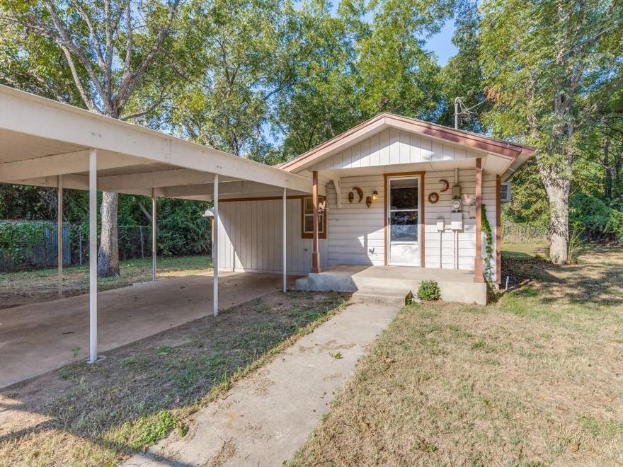 Owner financing is an option. Beautiful heavily treed half acre lot in quiet neighborhood. Home has one bedroom and one bath. Value is mostly in the property with a lot of trees. This setting could be perfect for a new single family home, add on to existing or new duplex. Home is in living condition and needs some updating. Property goes beyond the back fence. Carport is 33 by 12. The old water well shed is perfect for storage. It is on city water and sewer. Well water is used for irrigation and gardening.