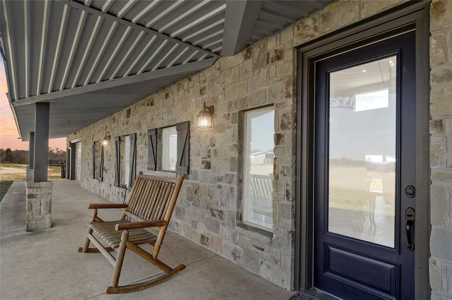 LUXURY FARM & RANCH ESTATE – TWO HOMES ON 33 ACRES! Experience unparalleled beauty and functionality on this private 33-acre estate, where upscale meets Texas ranch living. Thoughtfully designed & fully renovated in 2016, this fully fenced & cross-fenced property is ideal for livestock, with three barns accommodating animals, feed, tack, & workshop space. The main home, a 3,169 sq. ft. custom ranch style, offers 3 bedrooms, & 3 full baths, with a split-bedroom floorplan & exquisite high-end finishes throughout. Soaring ceilings & wood-look tile floors set the stage for the open-concept great room, where expansive windows capture breathtaking panoramic views & steller sunsets. The gourmet kitchen is a chef’s dream, boasting a massive island, dual sinks, granite countertops, and abundant storage. A dedicated office and an oversized upstairs loft provide flexible space for homeschooling, work, or play. The primary suite is a private retreat, easily accommodating a king-size bed & sitting area, with a spa-inspired ensuite featuring a soaker tub, tiled shower, dual vanities, & a walk-in closet. The East wing includes two additional bedrooms, a dual-sink full bath, a mudroom with quartz counters, sink, and a laundry room. A partially finished basement adds storm shelter space & additional storage. 
The 816 sq. ft. guest cottage is equally impressive, featuring full-length south-facing windows, sweeping, pastoral views, an open living area with an electric fireplace, a beautifully appointed eat-in kitchen, & a luxurious bathroom. Enjoy the screened-in front porch with jumbo daybed swing, front deck with an accessibility bridge, and a back deck for peaceful outdoor living.  
A rare offering of elegance, privacy, & ranch-ready amenities—this estate is a turnkey dream for its next discerning owner.  
Fully ag-exempt for low taxes, 60x40 Homestead barn on slab plus 36x45 barn with stalls. RV Parking & Hookups-Reach out for enhanced amenities & more photos. Too much to list!