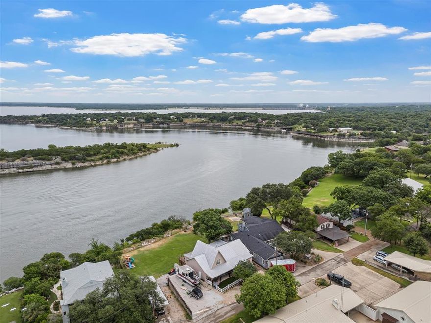 Unrivaled Views & Ultimate Lakefront Living on Lake Whitney! Welcome to your dream lakehouse retreat where panoramic views and a tranquil vibe create a memorable lifestyle. Perched on a premium vantage point, this 3 bedroom, 2 bathroom home offers arguably the best views on all of Lake Whitney. Every room captures the magic of the water, providing a front-row seat to stunning sunrises and tranquil evenings.

Step outside and you’ll find endless opportunities to entertain and relax. The expansive backyard is perfect for gatherings, while the covered back porchwith a built in outdoor area and hot tub creates an ideal space to unwind after a day on the lake. The front courtyard features easy maintenance turf, and the detached insulated workshop is temperature controlled with a covered carport that offers bonus space for hobbies or extra storage.

Located in a beautifully maintained, gated neighborhood, this home offers peace and privacy while remaining just a short golf cart ride to the marina and boat ramp. Bring your boat, lake toys, family, and friends this is the Lake Whitney oasis you’ve been waiting for. Come experience lake living at its best less than an hour from Waco and a quick drive to DFW!