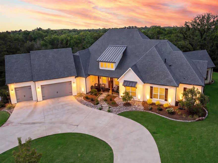 Tucked inside the gated enclave of Tanager Springs in between Denison and Sherman, Texas, this five-year-old residence captures the quiet elegance and easy sophistication that define Southern living at its best. Set on a full acre framed by mature hardwood oak trees, the home welcomes you with a sense of space, light, and thoughtful design that feels both refined and relaxed.
Step inside to a sweeping open floor plan crowned by vaulted ceilings, where natural light pours through a wall of windows stretching across the back of the home. These expansive views invite the outdoors in, offering a daily backdrop of wide Texas skies and gently swaying trees—an ever-changing landscape that feels like your own private retreat.
At the heart of the home, the kitchen is as functional as it is beautiful. Dual islands topped with striking leathered granite create the perfect gathering space, whether hosting a lively weekend brunch or a quiet evening supper. Abundant cabinetry and a spacious walk-in pantry ensure everything has its place, blending practicality with polished style. The open dining area flows seamlessly alongside, ideal for both intimate meals and larger gatherings.
The primary suite is a sanctuary unto itself, thoughtfully positioned apart from the secondary bedrooms for ultimate privacy. Its luxurious ensuite bath offers a spa-like escape, designed for unwinding at the end of the day. Meanwhile, a second living area provides a flexible space perfect for movie nights, gaming, or simply relaxing with loved ones.
A three-car garage adds convenience, while the expansive lot offers endless possibilities—from garden parties under the oaks to peaceful mornings with coffee on the patio.
In North Texas, where charm and community meet wide-open spaces, this home embodies a lifestyle that feels both elevated and warmly familiar—an invitation to slow down, settle in, and savor every moment.