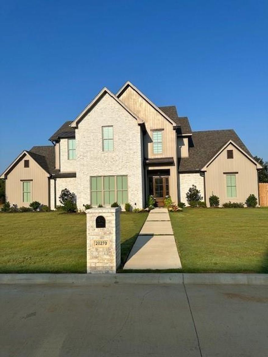 Beautiful two-story Modern Farmhouse design on 0.55+ acre corner lot in Antler Creek Estates, a new development in unincorporated southern Smith County, just off FM 346 W. The home, w a Bullard, TX address, is in Tyler ISD and only a short 8 minutes into Tyler.

The home boasts multiple upgrades & custom decorator features: marble countertops, custom flooring & cabinetry, window treatments & shades.
Entering the foyer, you see a large great room w Cathedral ceiling & fireplace.  Off the great room is a Chef's Dream Kitchen - expansive custom cabinets, marble countertops, top of line built-in Frigidaire Professional appliances, large center island w seating for four, huge walk-in pantry w custom shelving. Dining area between the great room & kitchen easily accommodates eight.

Large primary bedroom w space for king bed, dresser & chairs. Primary bath w beautiful tile flooring, dual vanities & sinks, Hollywood tub, and large separate shower. Expansive primary closet w custom, built-in dresser, shelving, and tri-level clothing racks. The laundry room, with custom cabinetry & large stainless steel sink, is conveniently adjacent to the primary closet.

Also downstairs - a guest bedroom w full ensuite bath; an additional half bath; large storage area under the stairwell; and mud room off the garage.

Upstairs has a fantastic media-home theater room that will accommodate a TV-media screen in excess of 120 inches, along with seating for six or more enthusiastic sports fans or movie buffs. Additionally upstairs are two more bedrooms and a full bathroom w dual sink vanity and separate toilet area.

Another great feature - two walk-in storage areas w full 8 foot door access upstairs. No more messing with a drop-down stairway to store your decorations!

Finally, an oversize 24x24 garage, w 18 ft door, easily accommodates two full-size vehicles & a golf cart. The side entrance driveway holds an additional 4 cars. AND, a huge backyard for entertaining.