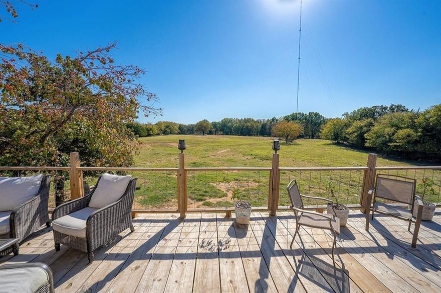 Use of Preferred Lender will offer to pay .75 points of buyer’s closing costs. Call TODAY to see if you Qualify! Unique Rustic Barndominium on Over 10 Acres! Discover the perfect blend of rustic charm and modern living in this stunning 2-bedroom, 1-bathroom situated on over 10 acres of breathtaking countryside. This property offers expansive views and ample space for relaxation, recreation, and work, making it a rare find. The spacious living areas feature exposed rafters that enhance the open feel, complemented by wide plank wood floors that add warmth and character. The gourmet kitchen boasts an open concept design that seamlessly flows into the living area, featuring butcher block countertops, a beautiful travertine backsplash, and a farmhouse sink with stunning views of the land. It comes equipped with stainless steel appliances and bar seating for casual dining. The master suite is thoughtfully located at the back of the home for added privacy and includes a private entrance into the rustic glam bathroom with double sinks on a repurposed dresser, elegant gold accent mirrors, and a tiled shower and tub area. The second bedroom is designed with a custom closet system, offering versatile storage options. Outdoor living is equally impressive with an expansive back deck, perfect for hosting gatherings or enjoying tranquil sunsets. Beneath the house, there’s an open stable area ideal for animals or extra storage. The property is fully fenced and cross-fenced, featuring an RV hookup complete with water, sewage, and electricity, along with a built patio for convenience. Additionally, a designated garden area includes a greenhouse and a fenced space ready for your gardening projects.Don’t miss this incredible opportunity to own a piece of paradise! Whether you’re looking for a serene retreat or an active lifestyle, this Barndominium has it all.