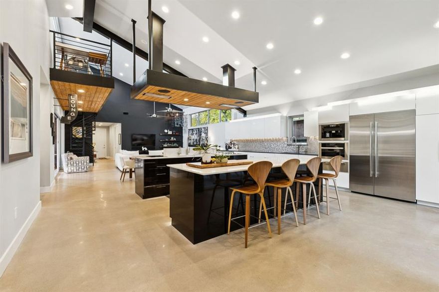 Step into a haven of modern living with this rare single-story, smart home, personally designed and built by the owner, featuring an elevation inspired by the renowned Joseph Eichler. Artfully crafted in mid-century style, this residence is ideally located near Inwood Village, Love Field and UTSW, making it a vibrant hub for both convenience and entertainment. For culinary enthusiasts, the heart of the home is truly remarkable. The expansive kitchen features not one, but two impressive 10-foot islands, complete with The Galley culinary system, top-of-the-line Wolf induction cooktops, and a convenient Miele coffee station, transforming cooking into an art form. Additionally, this kitchen is equipped with two Miele ovens—a Combi Steam oven and a full-size oven—adding versatility for all your culinary creations. Throughout the home, custom European-style cabinetry, painted with automobile paint, adds a unique touch of elegance and craftsmanship. Sleek concrete floors flow effortlessly throughout the main living spaces, creating a contemporary ambiance that is both elegant and functional. Your cozy primary bedroom offers a warm retreat, ensuring comfort at the end of a busy day. The spacious laundry room is not just practical but exceptional, featuring a dedicated sink, dog shower, abundant storage solutions, and secure safe rooms—a perfect blend of convenience and safety. Step outside to discover a generously sized patio, where sliding doors create a seamless connection to the living room, ideal for entertaining guests or enjoying peaceful moments in your private outdoor sanctuary. Additionally, the rear-entry garage features oversized bays with ample storage and is fully enclosed with an automatic gate for enhanced convenience and security. Embrace the opportunity to live in a meticulously designed home that marries style, functionality, and modern technology. Experience the allure for yourself—schedule your private tour today!