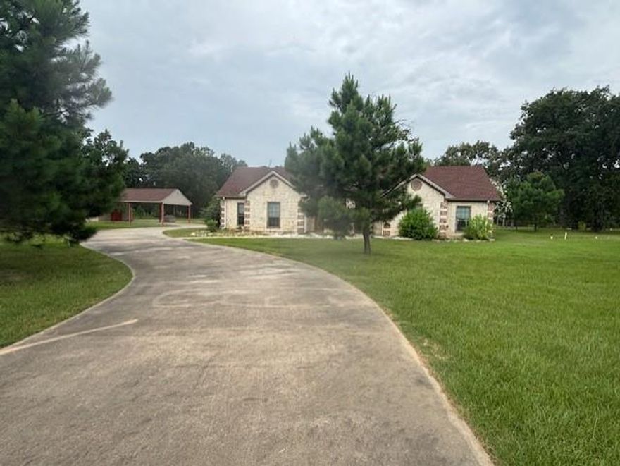 Experience the best of lake living with this beautiful 3-bedroom, 2-bathroom stone and brick home situated on 8.9 scenic acres directly across from the water. Designed for both comfort and functionality, the home features spacious living areas, ceramic tile throughout, and upgraded amenities including a split master suite with double lavatories and a luxurious walk-in bathtub. Two oversized living spaces provide ample room for relaxing or entertaining, making this home perfect for a growing family or weekend retreat. Step outside and take in the natural beauty of the acreage, complete with mature trees and open space ideal for exploring, gardening, or even expansion. The property offers a great setup for outdoor entertaining with plenty of room for gatherings under the stars. Whether you're looking for a peaceful permanent residence, a vacation home, or an income-producing AirBnB opportunity, this lakeside gem delivers it all. Don’t miss your chance to enjoy privacy, space, and the serenity of country living just steps from the lake.