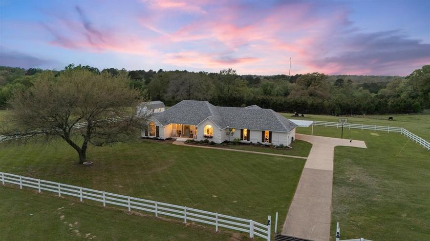 Welcome to your private sanctuary only 10 min from Longview.  This newly remodeled 4 Bd 2.5 bath home blends refined comfort with wide open freedom on 12 rolling acres complete with tight fences, offering the ideal setup for horses, homesteading, or simply savoring peaceful rural living. The thoughtfully designed interior features a dream custom kitchen, anchored by a large picture window over the sink that frames one of the most beautiful views imaginable.  Sunrises and sunsets here are unforgettable-visible for miles from the back covered back porch swing or while gathered around the fire pit.  The gorgeous laundry room, functional mudroom-office and luxury primary bathroom are designed for rest and retreat.  Every space has been beautifully updated, creating a move-in-ready home that feels both elevated and welcoming.  Outside, the land is equally inspiring.  The garden has already been tilled and is ready for planting along with making it easy to begin your homestead vision right away.  A huge barn- freshly updated with a new roof, paint and sliding barn doors-features full-length 15-foot lean-tos, horse stalls, and a tack room, providing everything needed for horses or livestock.   New roof on home 2021 as well as many updates including new custom kitchen cabinetry, new paint inside and out, light fixtures, flooring, updated bathrooms and much more!  The storage building includes electricity, AC-Heat unit and was used for additional living quarters-game room. Enjoy an evening around the fire pit, or collecting fresh eggs from the Hen Hacienda!  BEAUTIFUL COUNTRY SETTING IN A GREAT LOCATION! Make your appointment today to see this East Texas beauty.
