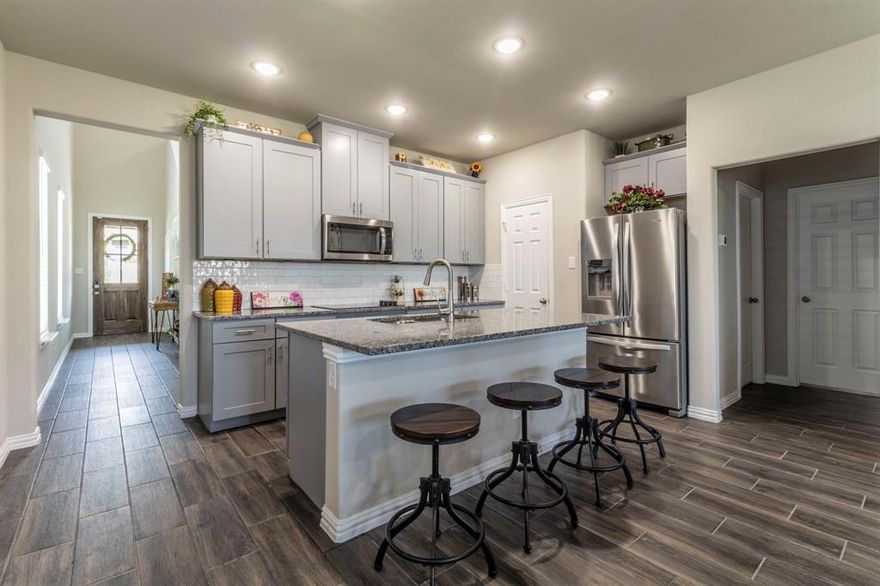 Rare Jewel in Pilot Point!
Step into this beautifully maintained rare jewel that outshines the surrounding new construction homes. This 3-bedroom, 3-bathroom home has an upstairs bonus room that can easily serve as a 4th bedroom or guest suite. Built in 2022 this elegant home has been gently lived in and is loaded with upgrades throughout. Features include a custom wood entry door with glass inlay, recessed lighting, ceiling fans, 4 inch baseboards, and an oversized storage closet under the stairs. The wood-look ceramic flank floors meets you at the entry and is carried throughout the 1st floor. The open kitchen offers 42 inch upper cabinets with crown molding, soft-close drawers and cabinets, custom paint and pulls, level-two granite countertops, ripple-glass subway tile backsplash, deep double-basin sink, and flat-surface glass cooktop. The primary suite includes a spa-like bath with custom tiled shower, separate garden tub, dual sinks, decorative lighting, and a large walk-in closet. Additional highlights include 2 inch faux wood blinds, smart security system, programmable sprinkler system, garage door openers, and an upstairs bedroom with full bath and upgraded lighting. Whirlpool refrigerator and GE washer and dryer convey. Conveniently located in Pilot Point with easy access to Denton, Aubrey, Celina, Frisco, Prosper, and Lake Ray Roberts. Move-in ready and full of value.