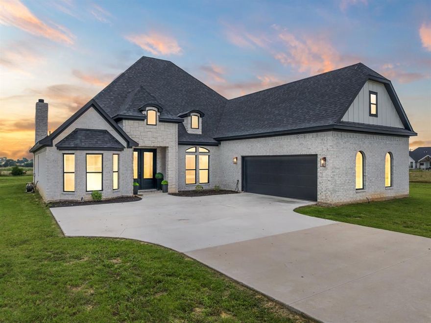 Stunning, newly built home by FLC Properties!  This custom 4-bedroom, 2-bath home sits on just over 1 acre in a quiet country setting with room to stretch out. Step inside to an open-concept layout with soaring ceilings, modern finishes, a split-bedroom floorplan, and a dedicated media room—perfect for movie nights, game days, or a quiet retreat. The large kitchen offers ample counter space and storage—perfect for family meals or entertaining. Custom touches such as wooden accents, built in desk, coat rack with shoe storage, and dual sinks in each bathroom. Enjoy peaceful mornings or evening sunsets relaxing on your back patio living space next to the cozy fireplace with wide-open rural views!  Plenty of room for a garden or workshop. Located outside of the city limits but just minutes from town and I-35 is your hard to find blissful retreat with close conveniences. NO HOA but deed restricted to 2000+ sqft homes to keep the area cohesive. Move-in ready and waiting for you!