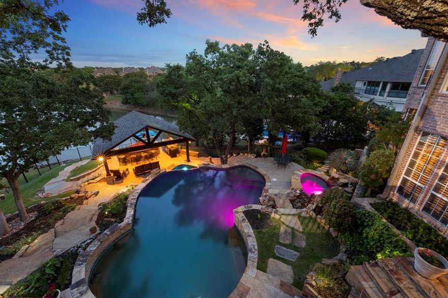 Phenomenal views at this DIRECT LAKEFRONT property in coveted Highland Shores.  The backyard oasis features an amazing infinity pool, spa, full kitchen, tv, misters, heaters and more! You will love the beautiful sunrise views and equally love the afternoon shade allowing you to be comfortable even in the hottest part of the day.  This meticulously maintained 4 bed, 4.5 bath brick and stone home has updates galore!  No expense was spared in the recently updated kitchen, master bathroom, custom closet, powder room and more. This magnificently landscaped cul de sac home feeds to highly rated LISD schools.  This is truly a must see property!