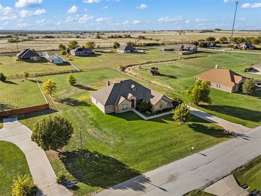 PEACEFUL COUNTRY LIVING MINUTES FROM DECATUR AND DENTON! This beautiful single story home in Decatur sits on a spacious 1 acre lot in a quiet established neighborhood with no city taxes. Enjoy wide open views, room to roam, and a layout designed for both everyday living and entertaining.

The open concept floor plan offers a large living area with wood flooring, a stone fireplace, and a wall of windows overlooking the backyard. The kitchen features an oversized island with seating, granite countertops, generous cabinet storage, stainless appliances, and a separate dining area with backyard views. The private primary suite includes a soaking tub, walk in shower, dual sink vanity, and a large walk in closet. Secondary bedrooms are separated from the primary for privacy and convenience, with a shared bathroom featuring dual sinks. A dedicated laundry room offers extra storage and workspace.

Step outside to a covered back patio perfect for relaxing, grilling, or watching sunsets. The property offers space for a future shop, pool, garden, or outdoor living expansion. Located close to Decatur schools, shopping, restaurants, Highway 287, and easy access to Fort Worth and surrounding communities.

If you are looking for an updated home with acreage and modern comfort in Wise County, this one is a must see. Ideal for those wanting space, simplicity, and a move in ready home on land.