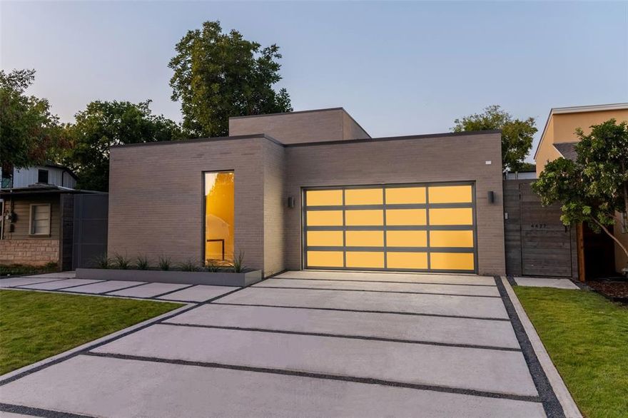 Architecturally significant home powered by AM Homes. This neutral modern palette will take your breath away. The exterior facade is the lightest of greys accented by rich, powder-coated planters and a matching perforated metal gate. The side entry is private but still inviting. Salt-finished concrete pavers lead you to the solid wood front door flanked by glass and a planter filled with agave. Inside, floor-to-ceiling white oak wall paneling stretches from wall to wall. You are immediately drawn into the main living area where a 40’ span of glazing showcases your dipping pool framed by a Brazilian hardwood deck. The east-facing wall of glass allows for plenty of natural light in the AM. Opposite the pool, the kitchen. The kitchen cabinetry is masterfully stained and topped with leathered Platino Quartzite. The Thermador appliance package is the icing on the cake, but the built-in Thermador espresso machine is a dead giveaway no expense was spared. The center island is the showpiece of the house. The Quartzite stone pierces through the Porcelanosa floors and a thick white oak built-in table wraps the stone and extends out to create an innovative dining experience. The living area is spacious with views of the pool, built-in cabinets, and direct access to a second outdoor living space. The master retreat privately sits on the first floor with views of the pool and direct access to the pool for late-night dips. The master bath has floor-to-ceiling windows providing some of the best natural lighting you will ever experience. The custom closets are 24” deep to keep all your clothes hidden from daily view. The countertops match the kitchen with the Platino Quartzite but are accented by gunmetal finished fixtures from Waterworks. The spa-like shower-bath combo is a place to relax away from all the problems of life….