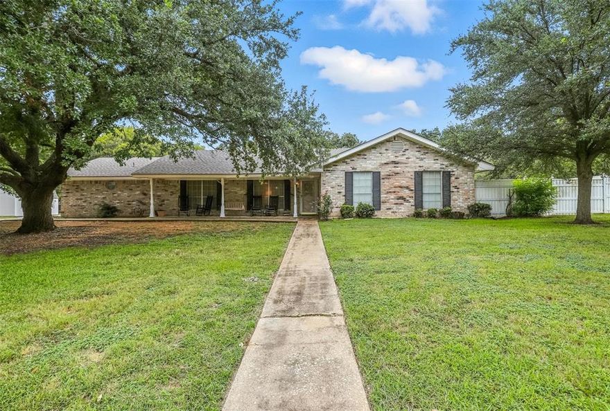 Discover the perfect blend of country living with modern convenience! Nestled on an expansive .85 acre lot, this home features 4 spacious bedrooms and is ideally located just moments away from schools, the Chisholm Trail, shopping, and more. With 2819 sq ft of space, there’s ample room for everyone to thrive! Step into the inviting living area, where a stone wood-burning fireplace creates a warm and welcoming atmosphere, seamlessly flowing into the dining and kitchen spaces. The generous formal dining area is perfect for hosting large gatherings and special occasions. An office area offers versatility, easily transforming into a fifth bedroom if desired. Unwind in the second living area, perfect for reading or simply relaxing. The  primary bedroom boasts an ensuite bathroom for your privacy, while two additional bedrooms on this side of the home provide comfort and convenience. A delightful bonus room off the living area offers endless possibilities. This property also includes a 3-car garage and two spacious storage buildings to meet all your organizational needs. Plus, enjoy the benefits of RV parking with a carport equipped with 50 amp service and a sewage pump. This remarkable home is a unique opportunity you won’t want to miss!