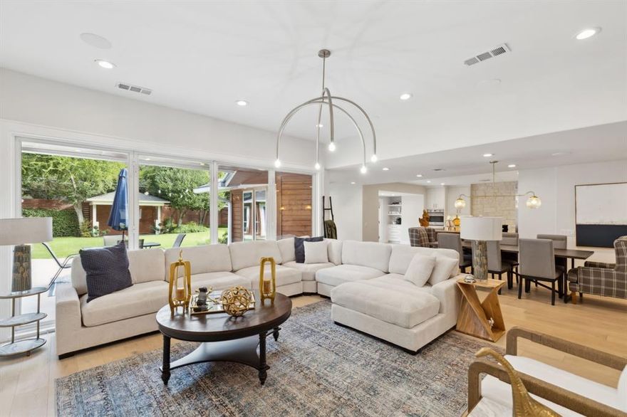 The perfect property for flexible living options. Welcome to 5973 Northaven Rd, beautifully renovated within the past 3 years, including a guest suite with a kitchenette, full bath and stackable washer and dryer area. The home, in the private school corridor, sits on a gorgeous lot in the heart of Preston Hollow with easy access to multiple shopping and dining options. Step through the glass framed front doors into an open concept, spacious living room with multiple dining areas and a entertainer's dream kitchen.  Beautiful wide plank oak floors throughout the house, custom cabinetry, floor to ceiling windows with views of the generously apportioned back yard with room to add a pool. The kitchen includes Viking appliances, an island with additional storage, beverage fridge, ice maker and a coffee bar. The sunken bonus room with coffered ceilings can function as an office, dining room or additional living space. Don't miss the primary suite with a huge ensuite and two walk-in closets.