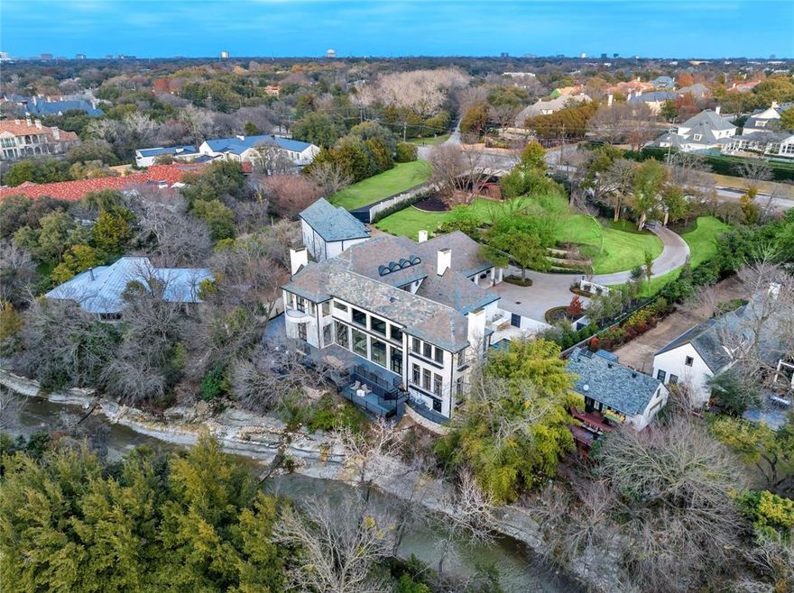 Owner financing available for qualified buyers with 25% down at 6.5% interest. A rare opportunity to own an architecturally significant residence designed by renowned modernist architect Bud Oglesby. Beautifully renovated & expanded in 2023. Sited on 1.83 acres of lushly landscaped grounds, this walled & gated property is very private & offers an oasis in the heart of Preston Hollow. Multiple living areas flow seamlessly & feature high ceilings, walls of glass & are flooded with natural light. Living spaces flow naturally to the outdoor entertaining areas. Especially stunning is the large multi-level deck which seems to float above the limestone lined creek shared with multi-acre Strait Lane Estates. Features a newly built 2-story garage with 5 bays & room for lifts. Above is an additional 1,653 SF guest apartment with two en-suite bedrooms & kitchenette.The park-like estate includes a large motorcourt, regulation pickleball sports court as well as pool, spa & outdoor grilling station.