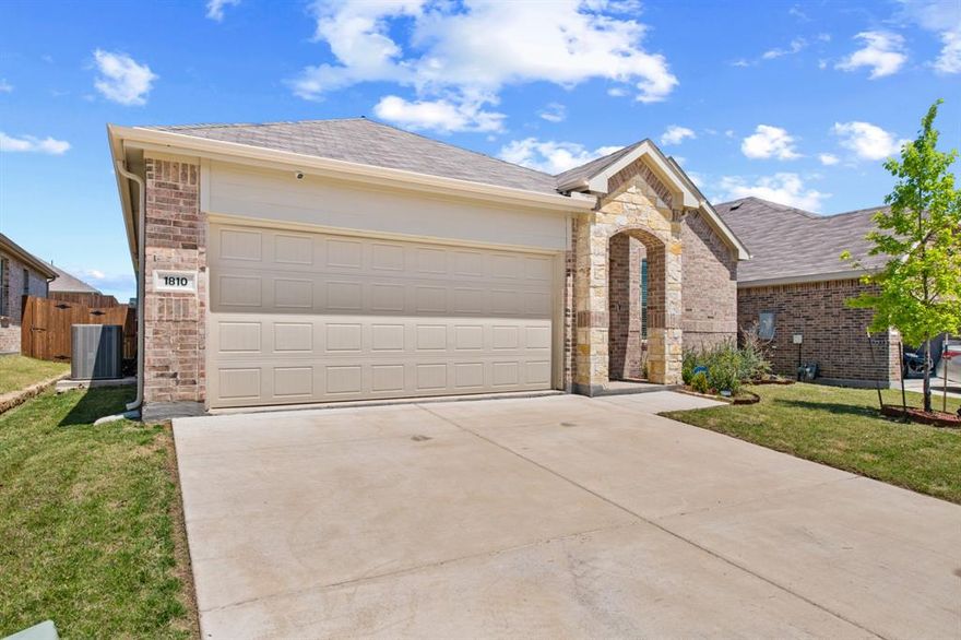 Welcome home to 1810 Memorable Moment Drive, a beautifully crafted 2024 Lennar home in the desirable Eastland community of Crandall, Texas. This single level gem effortlessly combines modern design with everyday comfort. From the moment you arrive, the charming curb appeal sets the stage for a home that is as inviting as it is functional.

Step inside to a bright, open layout that seamlessly connects the family room, dining area, and kitchen. This spacious design is ideal for entertaining guests or relaxing on quiet evenings. The stunning kitchen is a true centerpiece, boasting sleek granite countertops, a large breakfast bar, a walk in pantry, and highly efficient gas appliances. Gorgeous Luxury Vinyl Plank flooring flows through the main living areas, adding modern elegance while remaining incredibly easy to maintain.

When it is time to unwind, retreat to the private primary suite thoughtfully tucked away at the back of the home. This peaceful sanctuary features a generous walk in closet and a beautiful attached bathroom complete with dual sinks and a dedicated linen closet. Two additional bedrooms are situated toward the front of the home, offering plenty of space for family, guests, or a home office, all conveniently sharing a stylish second full bathroom.

The appeal extends outside, where a covered back patio overlooks your private backyard enclosed by a wood fence. It is the perfect setting for weekend barbecues or enjoying your morning coffee. Beyond your front door, the vibrant Eastland community invites you to enjoy resort inspired living with exclusive access to a sparkling community pool, neighborhood parks, playgrounds, and paved sidewalks. Complete with smart home technology and an attached two car garage, this remarkable property is completely ready for you to move right in and make it yours!