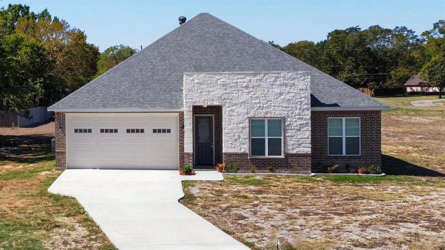 Don't miss out on this New Year's price drop and $6,000 in flex cash!! Check out this gorgeous custom new build with plenty of space. This stunning one-story home offers 2,170 sq. ft. of living space and over 2,700 sq. ft. total. With 4 bedrooms and 2.5 bathrooms, it perfectly blends style and function. Enjoy soaring 12-foot ceilings in the main living area and 10-foot ceilings throughout the rest of the home. The open-concept living, kitchen, and dining area features a gas fireplace, a large island with seating, and beautiful outdoor views. The stylish kitchen includes custom cabinetry, quartz countertops, a stunning backsplash, and a walk-in pantry. Extras include a laundry room with cabinetry, a massive garage, and charming brick-and-stone exterior. Outdoor living is a breeze with a covered front porch and a spacious covered back patio, ideal for relaxing or entertaining. Don’t miss out—schedule your appointment today!