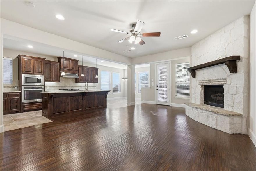 STUNNING HOME NESTLED ON A PICTURESQUE GREENBELT LOT, LOADED WITH LUXURY UPGRADES! Prepare to be impressed by this beautifully appointed residence, styled to perfection and designed for both elegance and everyday comfort. Step inside to discover extensive hand-scraped wood flooring, wrought iron spindles, plantation shutters, crown molding, and soaring ceilings that create a grand yet inviting atmosphere. A striking floor-to-ceiling stone fireplace anchors the open-concept living area, while a recently replaced roof adds peace of mind. The gourmet kitchen is a true showpiece, featuring granite countertops, stainless steel appliances, a 5-burner gas cooktop, under-cabinet lighting, a spacious island with a breakfast bar, and a pantry outfitted with a built-in spice rack. Retreat to the luxurious downstairs primary suite offering a dual-sink extended vanity, soaking tub, separate shower, linen closet, and an impressive walk-in closet. Upstairs, enjoy a wealth of additional living space with a generous game room, a private media room, and secondary bedrooms—each offering walk-in closets for exceptional storage. For those who work from home, the stylish office makes a statement with marble flooring and French doors. Step outside to your private, tree-lined backyard oasis backing to a serene greenbelt. With gravel side yards, abundant room for outdoor fun, and a large covered patio complete with a ceiling fan and gas stub for a grill, this space is ideal for gatherings or quiet evenings outdoors. Boasting epoxy flooring, the 2-car garage makes parking convenient and secure. Lantana residents enjoy resort-style living with pools, fitness centers, new pickleball courts, trails, and top-rated schools—just minutes from premier shopping and dining. 9328 Kaitlyn Court is a gorgeous home that offers luxury, comfort, and lifestyle—all in one perfect package. Don’t miss this opportunity to make this beautiful home yours!