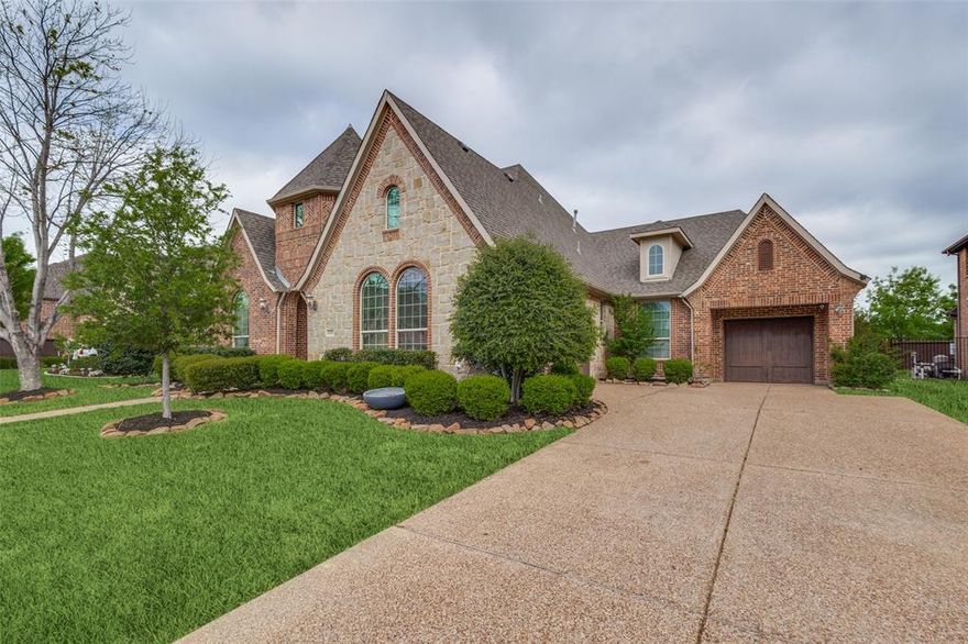 Welcome to this stunning single-story executive home nestled in the highly sought-after Turnberry neighborhood of Trophy Club. Thoughtfully designed and beautifully appointed, this residence showcases elevated finishes, including hand-scraped hardwood floors, Taj Mahal quartzite countertops, plantation shutters, and a dramatic floor-to-ceiling stone gas fireplace.  Spanning approximately 2,977 square feet, the home offers a spacious and functional layout with 3 bedrooms, 3 full bathrooms, a private office, formal dining room, and a three-car garage.  The chef’s kitchen is both stylish and functional, featuring a 5-burner gas cooktop, brick backsplash, and an expansive quartzite island—perfect for everyday living and entertaining.  The primary suite is a true retreat, complete with a luxurious ensuite bath showcasing dual vanities with quartz countertops, an oversized walk-in shower with dual shower heads, a standalone soaking tub, and a custom walk-in closet with California-style built-ins. A secondary bedroom is thoughtfully separated, offering privacy along with its own adjacent bathroom featuring a frameless glass shower.  Step outside to a beautifully landscaped backyard with a covered patio—ideal for relaxing or hosting guests.  Ideally located near Trophy Club Country Club, featuring two premier golf courses, and surrounded by community amenities including pools, parks, dog parks, playgrounds, fishing ponds, and scenic walking trails. Enjoy convenient access to shopping, dining, and Highway 114 for an easy commute.  This home offers the perfect blend of luxury, comfort, and location.