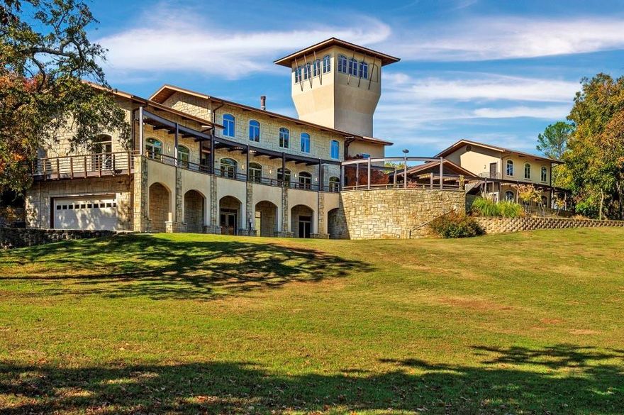 Quality 6 bedroom 4+ bath home located on 4+ acres with Lake Frontage and direct access to beautiful, sandy Sycamore Beach. Custom-Built, Professionally designed and engineered. Outstanding attention to detail throughout. Superb fit and finish. Crafted for low-maintenance outdoor and indoor living. Exterior limestone was hand-cut and fitted on-site, to ensure a perfect fit. The main house features 4 levels; (1) a Walk-out Basement with a huge Media Room, garage, and steam room, (2) the main floor with Great Room, fireplace, kitchen, primary bedroom suite, saltwater hot tub and stunning lake view balcony, (3) 2nd floor, with Lakeview Office overlooks the great room and the beach, this floor also offers a Great Library and a Guest Bedroom suite, (4) Finally the Tower (44') up offers views above the trees. All floors are served by an Elevator. Large Screened Patio connected by a covered walkway, to the home, and the 2 private 2-1 Guest Suites, Caretaker Cottage, and Storage-Shop included.