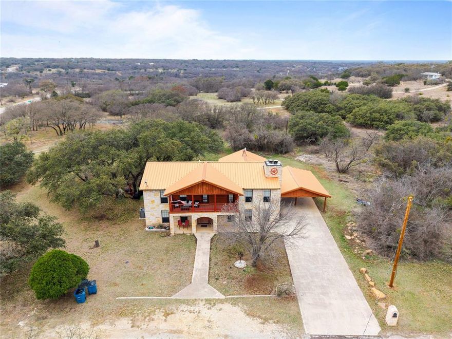 Perched on a hilltop just a block from Lake Brownwood, this home offers the kind of lake living people dream about—wide views, cool breezes, and plenty of room for family & friends to gather. This stunning two-story Austin stone home makes a bold first impression with its distinctive copper metal roof, matching gutters, & timeless Hill Country charm. 

Inside, the spacious layout offers five bedrooms, including two primary suites—one conveniently located downstairs & another upstairs. Two separate living areas provide room to spread out, with one featuring a cozy wood-burning fireplace.

The beautifully remodeled kitchen is thoughtfully updated & designed for both function & gathering. With 2 dining areas nearby & all appliances included, entertaining family & friends is effortless whether it’s a casual weekend at the lake or a full time living.

The recently added downstairs primary suite offers its own exterior entrance, a spacious walk-in closet, & a luxurious en suite bath with an extra-large tiled shower.

Upstairs, the 2nd primary bedroom delivers its own unique charm with a wood-burning fireplace, a large walk-in closet, access to the front balcony, & a private rear balcony for quiet mornings with coffee or evening sunsets.

Step outside and you’ll discover the perfect backyard setting for outdoor living. Mature oak trees provide generous shade across the yard, creating a relaxing sitting area beyond the large covered back patio.

The upstairs could benefit from new flooring, & the seller is making it easy with a $10,000 flooring allowance, giving buyers the opportunity to add their own personal touch.

With space for the whole crew & the water just moments away, this property offers the perfect blend of comfort, character, & location. Gather the family, invite the friends, & make this your home base for unforgettable summers at Lake Brownwood.