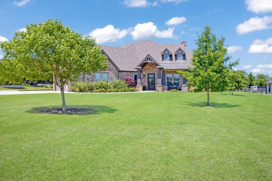 Stunning, Sophisticated Country Estate home on 1 acre.  This custom-built home is so inviting, open, and comfortable. The finishes are beautiful inside and out. There are 3 spacious bedrooms, plus an office with a closet. The Primary Ensuite is truly a retreat. There are 2 separate vanities and a walk-in shower with a bench. The counters are black leathered granite, which look so sharp! The walk-in closet is amazing. It has room for an island dresser. The engineered wide-plank floors throughout most of the home are gorgeous. The only carpeted rooms are the 2 secondary bedrooms. The family room has a vaulted ceiling and features a floor-to-ceiling fireplace. Bookshelves and cabinets flank the fireplace. The family room is open to the kitchen and dining. The open plan is so inviting and is a great space for entertaining. The kitchen has a large quartz island, a gas cooktop, and lots of counter space. The large windows across the back of the home allow for tons of natural light. Besides the gorgeous home, the back porch and back yard will definitely draw you in! The stunning back porch is private and spacious, serving as an additional living area. The owners built a wood privacy fence for a small, secure yard for a dog or young child. The entire backyard is fenced with pipe fencing. Please ask the listing agent to send you the video of the backyard from last Spring. The yard is full of perennial flowers and fruit trees. The buyer of this property will literally get to enjoy the fruits of the labor from this Master Gardener seller.  The 25x25 garage has stairs that walk up to a fully floored attic with spray foam insulation. The construction and energy efficiency in this home is top notch!  The foundation has piers in the slab. This desirable neighborhood has some restrictions, but no HOA. You will know that you are HOME as soon as you turn onto this beautiful road. The tax rate is $1.67. Van Alstyne is a thriving small town with great schools. VAISD is A-rated