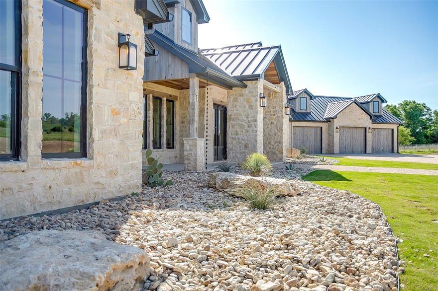 Immerse yourself in a world nature & relaxation at this Hill Country estate on 32 park-like acres. With its careful craftsmanship & sophisticated finishes, this resort inspired 3714sqft. home embodies luxury, tucked away in the quiet & beautiful countryside. Reclaimed wood beams, soaring stone fireplaces & breathtaking TX views all come together in this one-of-a-kind home. Boasting sensational amenities & stunning features throughout, no detail was overlooked. Awe inspiring chef's kitchen w an expansive leather granite island. The living room is highlighted by cathedral ceilings, Granbury stone walls, windows, & sliding glass doors. Gorgeous primary ste w private stone fireplace & divine spa like bath. Split guest rooms. Beautiful study. TX dream garage for 3 duallys. 50x50 shop to hold your bus, trailer, tractor & boat all at once. Lush rolling pastures & astounding trees! Seasonal Creek, Sandy Loam, Pipe Fencing, & 2 water wells. Newly constructed 7 stall barn. 135x235 arena pad.