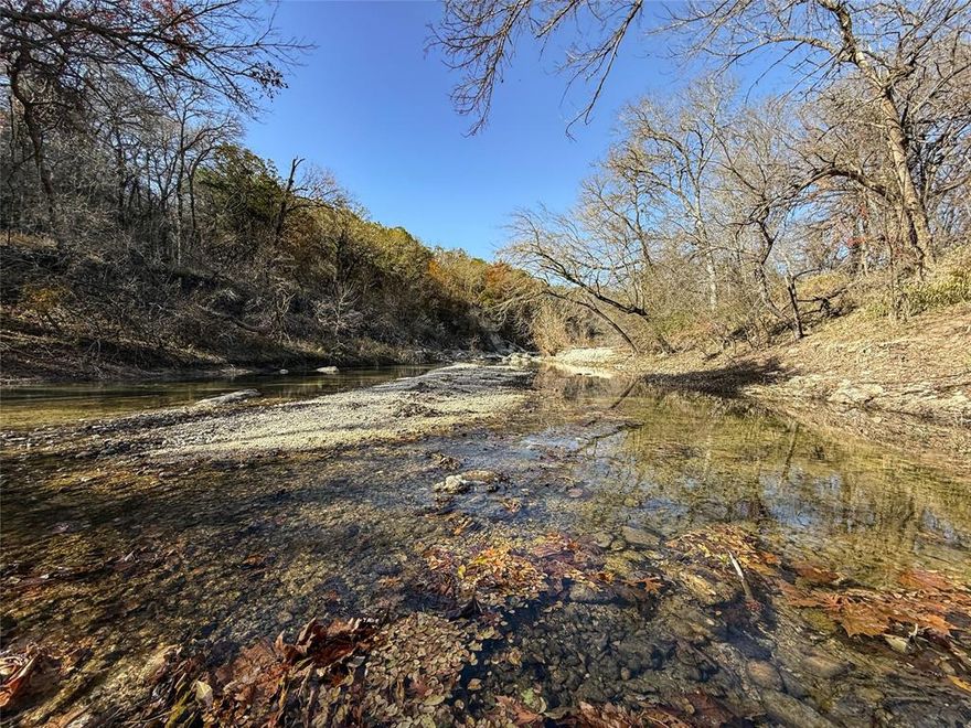This exceptional 103.682-acre recreational ranch offers the ultimate Texas hunting and lifestyle property. Located just minutes from Crawford and Valley Mills, with easy access to Waco, the property features 1,900 linear feet of pristine Middle Bosque River frontage, two productive ponds, and abundant wildlife habitat. The established A-frame cabin with utilities provides an immediate retreat option. This rare combination of river frontage, hunting potential, timber, and infrastructure makes it an exceptional investment opportunity.

Property Highlights

• 103.682 acres of prime recreational property with exceptional topography

• 1,900 feet of Middle Bosque River frontage —rare riverfront amenity providing scenic beauty and wildlife access

• 110-foot elevation change for scenic vistas and diverse habitat

• Established A-frame cabin (600 sq. ft.) with water meter and electric meter installed

• Two productive ponds —excellent for waterfowl, wildlife watering, and recreation

• Diverse timber stand including mature pecan, live oak, cedar elm, and premium hardwoods

• Paved road frontage for easy access and visibility

• Prime hunting opportunities for whitetail deer, hogs, dove, and ducks

Hunting & Recreation Potential

This property is a hunting enthusiast's dream. The diverse habitat supports thriving populations of whitetail deer, feral hogs, dove, and waterfowl. The Middle Bosque River offers excellent duck and goose hunting, while the timber and open areas attract consistent deer movement. potential for waterfowl hunting and fishingishing potential. The topography and acreage allow for multiple hunting scenarios and the development of dedicated hunting areas.

Location & Accessibility

To Waco, 31 miles

To Crawford, 5 miles

To Valley Mills, 10 miles