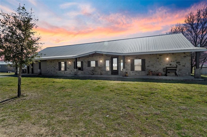 LUXURY FARM & RANCH ESTATE – TWO HOMES ON 33 ACRES! Experience unparalleled beauty and functionality on this private 33-acre estate, where upscale meets Texas ranch living. Thoughtfully designed & fully renovated in 2016, this fully fenced & cross-fenced property is ideal for livestock, with three barns accommodating animals, feed, tack, & workshop space. The main home, a 3,169 sq. ft. custom ranch style, offers 3 bedrooms, & 3 full baths, with a split-bedroom floorplan & exquisite high-end finishes throughout. Soaring ceilings & wood-look tile floors set the stage for the open-concept great room, where expansive windows capture breathtaking panoramic views & steller sunsets. The gourmet kitchen is a chef’s dream, boasting a massive island, dual sinks, granite countertops, and abundant storage. A dedicated office and an oversized upstairs loft provide flexible space for homeschooling, work, or play. The primary suite is a private retreat, easily accommodating a king-size bed & sitting area, with a spa-inspired ensuite featuring a soaker tub, tiled shower, dual vanities, & a walk-in closet. The East wing includes two additional bedrooms, a dual-sink full bath, a mudroom with quartz counters, sink, and a laundry room. A partially finished basement adds storm shelter space & additional storage. 
The 816 sq. ft. guest cottage is equally impressive, featuring full-length south-facing windows, sweeping, pastoral views, an open living area with an electric fireplace, a beautifully appointed eat-in kitchen, & a luxurious bathroom. Enjoy the screened-in front porch with jumbo daybed swing, front deck with an accessibility bridge, and a back deck for peaceful outdoor living.  
A rare offering of elegance, privacy, & ranch-ready amenities—this estate is a turnkey dream for its next discerning owner.  
Fully ag-exempt for low taxes, 60x40 Homestead barn on slab plus 36x45 barn with stalls. RV Parking & Hookups-Reach out for enhanced amenities & more photos. Too much to list!