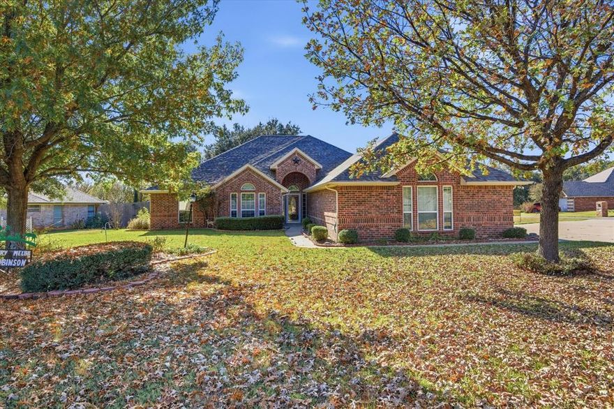 ONE OWNER 4-2-3 BRICK HOME ON LARGE LANDSCAPED CORNER LOT; Chris Thomas Built Home; Fresh Interior Paint;  Parklike yard with oak trees and circle drive; open concept floorplan with 2 Living areas; 2 dining areas; private primary suite with large bath featuring walk-closet, Marble Tub and Separate Shower with 2 Vanities; Privacy fence back yard offers an open patio area with a retractable awning; pergola area; shaded by live oak tree; Granite Type kitchen counter tops with full ceramic backsplash; Family room offers gas log fireplace and access to the enclosed  17 X 13 patio-sunroom with heat and air vents (sunroom not included in home square footage);Sprinkler System; Full house gutter system with leaf guards; No city taxes; with low HOA Dues; Just a few miles to the Historic Granbury Square and a couple of blocks from Lake Granbury; 8' X 10' Storage Building in rear yard; floored attic area above garage;  Seller has no survey - buyer will need to order