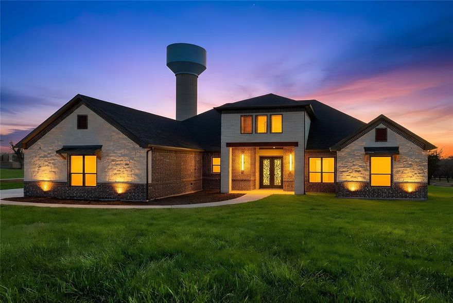 This exceptional 4-bedroom, 3.5-bath luxury modern farmhouse offers refined design, high-end finishes, and effortless indoor–outdoor living—all set within an exclusive gated community featuring a championship golf course, elegant clubhouse, and resort-style pool.

A bright, open layout welcomes you with expansive windows, clean architectural lines, and beautiful tile flooring throughout the main living areas. The spacious great room centers around a designer fireplace and flows seamlessly into the gourmet kitchen, creating an inviting space ideal for both daily living and entertaining.

The chef’s kitchen features gas-powered cooking, premium appliances, custom cabinetry, an oversized island, and a large walk-in pantry offering abundant storage. Just beyond, the impressive outdoor kitchen extends your entertaining options, perfect for gatherings, weekend grilling, or quiet evenings under the covered patio.

The luxurious primary suite provides a private retreat with a spa-inspired bath, freestanding soaking tub, dual vanities, and a generous walk-in closet. Three additional bedrooms offer comfort and flexibility for guests, family, or office needs, while 3.5 well-appointed baths ensure convenience for all.

Enjoy efficient gas heating, thoughtfully designed outdoor living spaces, and beautifully maintained surroundings. Residents benefit from secure gated entry and access to top-tier amenities including the golf course, clubhouse, and pool—creating a lifestyle that blends luxury, recreation, and modern comfort.

A truly remarkable home in one of the area’s most desirable communities.