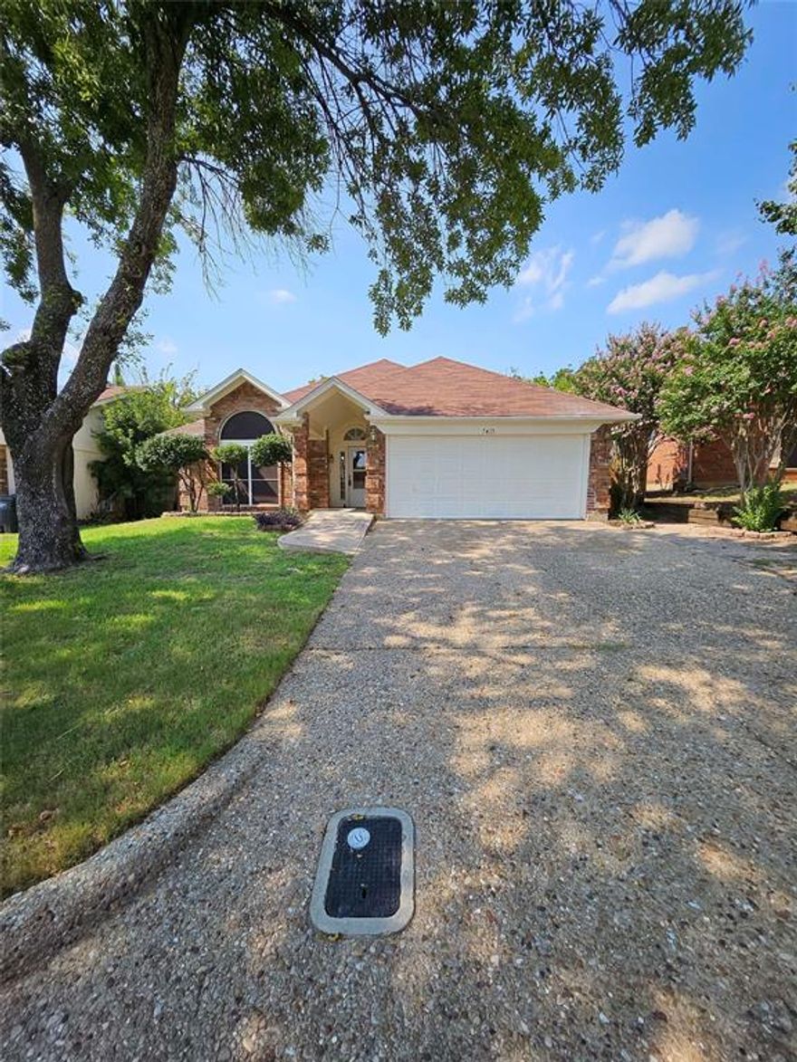 Beautifully updated 3-bedroom, 2-bath home in established Sandy Ridge Estates. This single-story home features an open floor plan with vaulted ceilings, ceramic tile flooring throughout, and a spacious living area with a cozy wood-burning fireplace. The eat-in kitchen boasts a large island, pantry, tile backsplash, and stainless steel appliances. The primary suite offers a double vanity, walk-in closets, and an updated bathroom with separate shower. Secondary bedrooms include ceiling fans and easy access to the full guest bath. Fresh interior and exterior paint. Outside, enjoy a covered patio, fenced backyard, and mature trees. No HOA. Convenient access to I-30, shopping, dining, and schools. Move-in ready!