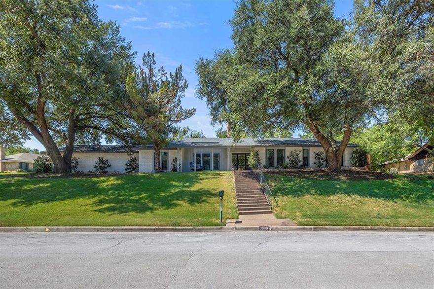 Perched on nearly half an acre on a beautiful, tree lined street in Overton West, 3808 Black Canyon blends timeless ranch charm with modern updates. Extensively renovated, this home offers an airy, open design with crisp finishes and an easy flow between living spaces. The kitchen shines with custom cabinetry, a spacious island, and designer details that make both everyday meals and entertaining a joy. Generous living and dining areas are bathed in natural light, highlighted by large windows that frame views of the lush backyard. The primary suite is a true retreat with a walk-in closet and spa-like bath featuring double vanities, a soaking tub, and separate shower. Outdoors, a covered patio with pergola extend the living space and overlooks the deep, expansive yard—ideal for play, gatherings, future additions and a pool. Conveniently located near Overton Park Elementary and in one of Fort Worth’s most desirable neighborhoods, this property offers the rare opportunity to enjoy modern comfort, space to grow, and the character of an established setting.