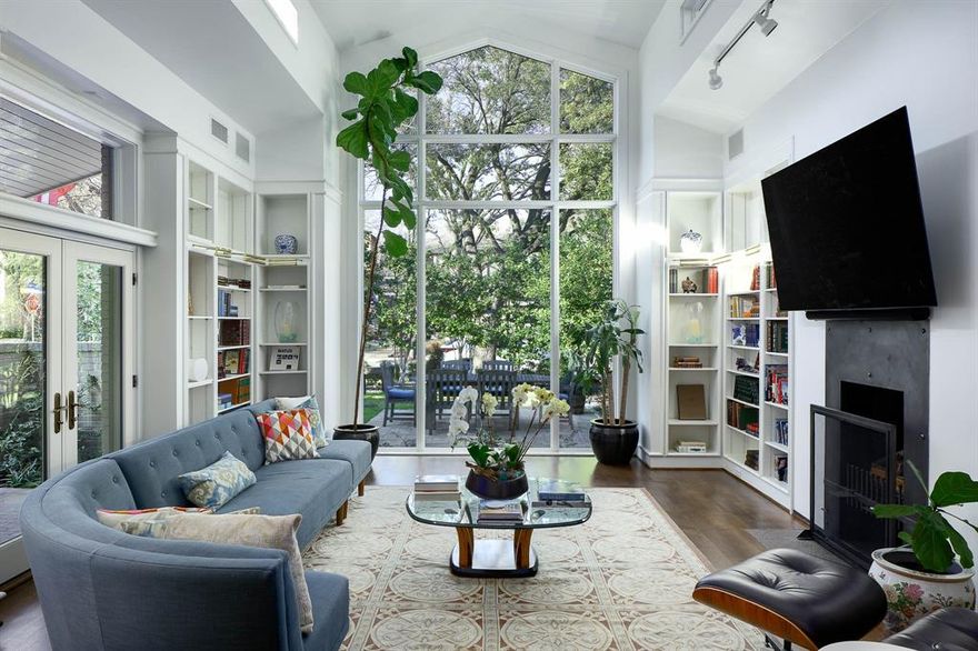 A true architectural masterpiece, this Highland Park residence is a rare find—originally designed by renowned architect, Bill Booziotis, and thoughtfully expanded by Mark Hoestery of SHM Architects. With exclusive secured access to the Katy Trail, this 3 bedroom home with over 4000 sf offers an unparalleled blend of livability and timeless design. Tucked away in a quiet cul-de-sac on a distinctive .25-acre lot, its secluded feel is enhanced by lush greenery, abundant natural light, and an exquisite interplay of indoor and outdoor spaces. From the moment you enter the gated courtyard, this home captivates with soaring vaulted ceilings, an organic flow, and stunning walls of glass that frame serene views at every turn. The dramatic main living area, with floor-to-ceiling windows, connects to the kitchen, and then to a second living space featuring a wet bar and dining area, and doors to a beautifully turfed yard and patio with a built-in grill. The updated kitchen offers ample storage, work-space and serving areas, and is perfectly positioned between the living spaces for both functionality and style. The first-floor primary suite is a calm retreat, complete with a sitting area, custom built-ins, French doors opening to the backyard, and a spa-like bath with dual closets. A study and a powder room complete the main level. Upstairs features two spacious bedroom suites with walk-in closets, a library or game room, and a dedicated laundry room. Additional highlights include a two-car garage with an EV charger, automated window shades in the living areas and primary suite, and a rare combination of privacy and accessibility. Just moments from the shops on Knox Street, Highland Park’s picturesque parks, and Armstrong Elementary, this home is an extraordinary opportunity for those who appreciate world-class architecture, thoughtful design, and a home that stands apart from the rest.