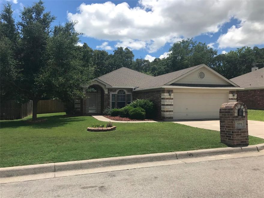 Introducing 521 Sweetwater Dr., a charming 3-bedroom, 2-bathroom home nestled in the desirable location of Weatherford, TX. This lovely house offers a range of amenities that will surely enhance your living experience. The fenced yard provides privacy and perfect for outdoor activities or simply enjoying the fresh air. Relax and unwind on the covered back patio, ideal for hosting gatherings or savoring a quiet moment alone. The wood-burning fireplace adds a touch of warmth and coziness to the living space, creating the perfect ambiance for those chilly evenings. The laminate flooring throughout the house adds a touch of elegance and is easy to maintain. With its prime location, ample amenities, and comfortable living spaces, 521 Sweetwater Dr. is the perfect place to call home. Don't miss out on this wonderful opportunity to experience the best of Weatherford living. Contact us today to schedule a tour and make this house your own.