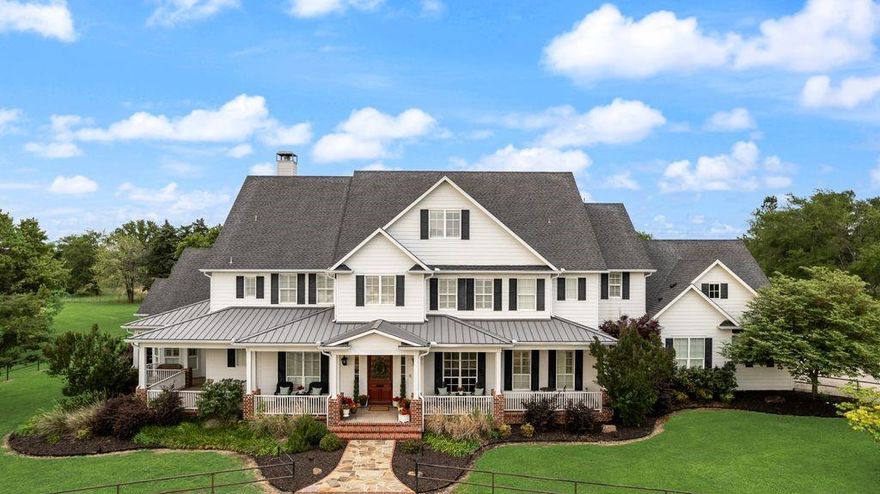 This stunning Southern Living-inspired dream home, situated on a sprawling 12.795 acre estate, blends timeless Southern architecture with modern luxury and functional recreational and equestrian facilities. TOTAL LIVING SPACE SF is 6,956.5 between the primary home and separate building. The property features a thoughtfully designed main house with a expansive front porch, custom millwork, light-filled living spaces, re-milled hand scraped wood flooring, and high ceilings with wood beams.  Additional interior features of this beautiful home include designer windows relocated from a Brookstone in NYC, several decorative transom windows, stained glass windows, plantation shutters, copper sinks, a variety of gorgeous light fixtures, antique washboard sink, luxurious primary bathroom with clawfoot tub and fireplace, decorative doors including dutch and barn doors, sophisticated wood and metal features throughout, a 5-Star 6-burner gas double oven, wet bar or wine area, office, reading room, gift wrap area, mudroom, formal living area, and over 400 sf of additional storage (no ac). The upstairs entertainment area features a HUGE game room (pool table stays) and media room (media chairs and projection equipment stays). And an extra plus - ALL bedrooms include ensuites with nicely sized walk in closets. 


Let's talk about the amazing outdoor oasis... This picturesque retreat includes a saltwater-chlorine combo pool and spa, fireplace, outdoor kitchen that includes a sink, gas grill, griddle and pizza oven. Additional features include a firepit, covered cabana with a daybed style swing, an enormous amount of open and covered space for entertaining, regulation size pickleball court, 1.5 acre pond, private gated entrance and entirely fenced. Last but not least, the 60x40 separate building has an additional 2 bedroom, 2 bath and open living-kitchen area, a great amount of storage capacity, and 4 walk-in horse stalls.