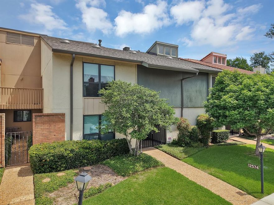 This unique townhouse in the Chimney Hill subdivision offers a tranquil living experience with an emphasis on peacefulness and community. The interior features a combination of ceramic tile, wood, and laminate flooring throughout its two levels. The heart of the home is an open living area centered around a masonry wood-burning fireplace, complemented by vaulted ceilings and decorative wood beams that create an airy and expansive feel. A separate dining area and a galley-style kitchen, complete with built-in cabinetry, a pantry, and a suite of white appliances, make the main floor both functional and inviting. Upstairs, the spacious primary suite serves as a true retreat, featuring its own private fireplace, a dedicated sitting area, and a large walk-in closet. The attached ensuite bathroom is well-appointed with dual sinks, a jetted tub, and a separate shower. Additional interior highlights include a bonus room with built-ins and a dedicated laundry area for convenience. The outdoor area is equally serene, with a private courtyard perfect for relaxation. This property combines unique architectural character with the convenience of a well-maintained home.
