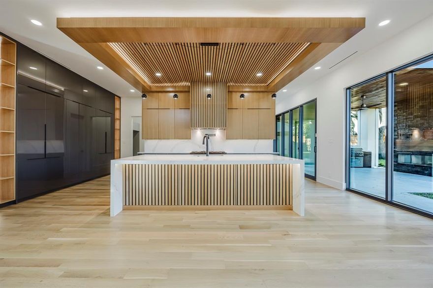 Nestled in prestigious Preston Hollow, this stunning contemporary residence fuses modern elegance with a highly functional layout—offering rare access to Dallas’s coveted private school corridor.

The open-concept living space is perfect for entertaining, while the downstairs study with custom cabinetry creates an ideal home office or library.

The primary suite showcases peaceful views of the backyard with room for a future pool, creating a true private retreat. A first-floor guest suite adds convenience and flexibility for visitors or multigenerational living.

Wine enthusiasts will appreciate the sleek, glass-enclosed wine room—an impressive showcase for your collection. Upstairs you’ll find three ensuite bedrooms, a spacious game room, and an open loft.

Additional highlights include a rare 3-car garage and elevated prewiring throughout: audio, video, security, and motorized window treatments all centralized for the buyers convenience for a future home automation. Three garage outlets are wired for EV charging, the patio is wired for future ceiling heaters, and is prepped for future patio screens.

This is an extraordinary modern home in one of Dallas’s premier neighborhoods. Experience design, function, and location at its finest. Explore everything this masterpiece has to offer!
ASK ME ABOUT THE RATE BUY DOWN!