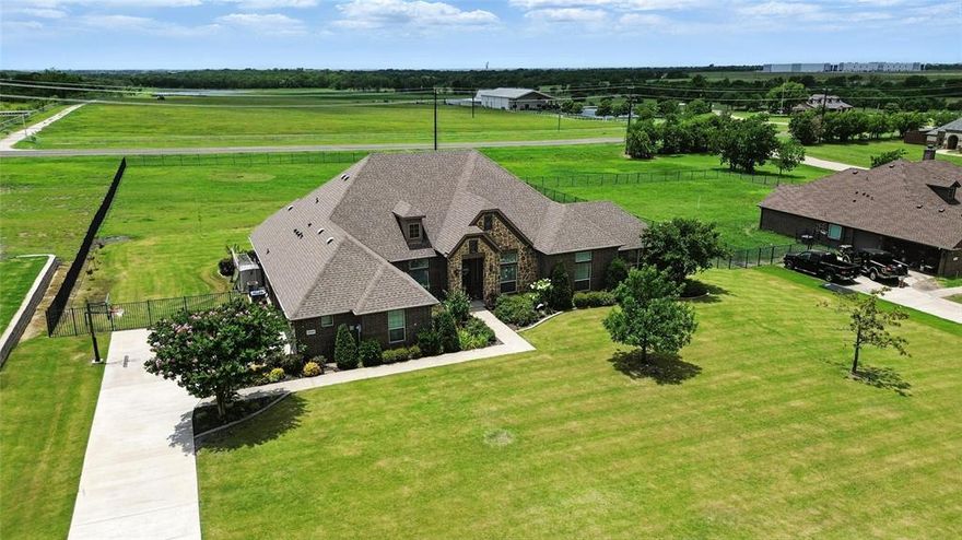 Welcome to 12022 Livingston Way, nestled in the highly sought-after Founders Addition of Talty, TX. This stunning 4-bedroom, 3-bath home sits on over 1.2 beautifully landscaped acres and offers 3,002 square feet of thoughtfully designed living space—all on a single level. Step inside to an open and inviting floorplan featuring elegant wainscoting, decorative lighting, and spacious living areas with rich stonework and a cozy wood-burning fireplace. The chef-inspired kitchen is a dream with granite countertops, a large island, breakfast bar, double ovens, built-in cabinets, and a walk-in pantry—perfect for entertaining or everyday living. The primary suite is a true retreat with a sitting area, walk-in closet, and spa-like bath complete with garden tub, separate vanities, granite counters, and a walk-in shower. All secondary bedrooms are generously sized and include ensuite baths and walk-in closets. A dedicated home office and oversized game room provide flexible space for work or play. Enjoy outdoor living on the covered back patio with built-in BBQ, surrounded by lush gardens, wrought iron fencing, and a sprinkler system. The oversized 3-car garage (20x30) offers ample space for vehicles and storage. Located in Forney ISD and minutes from city conveniences, this meticulously maintained home offers the perfect blend of space, comfort, and style in a peaceful, upscale neighborhood.