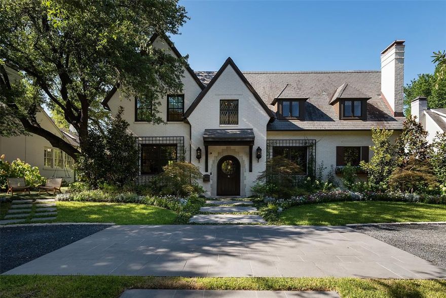 Located in Northern Hills, built in 1926, this breathtaking transitional-style home has been extensively updated twice—expanded in 2015 under the design of architect Lloyd Lumpkins and builder Randy Hughes, then exquisitely remodeled again in 2021 with interiors and grounds by David Brothers and builder JJ Cain. Every square inch of the 6,050-square-foot home boasts a sleek transitional design that perfectly complements the original English cottage-style architecture.  Meticulous care was taken to remain faithful to this home’s heritage while bringing it into the modern era with every detail and convenience today’s discerning buyer expects. The five-bedroom, four full and two half bath property also features seven covered parking spaces, an elevator, primary suite with en suite library and his-her walk-in closets, a pool and outdoor living area, a den, a media room, and a bar.