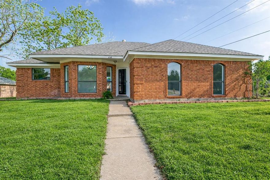 Charming single-story home in the heart of Coppell offering a light-filled, open layout and inviting spaces throughout. This 3-bedroom, 2-bath residence features beautiful wood-look flooring, vaulted ceilings, and a spacious living area anchored by a cozy fireplace and walls of windows overlooking the backyard. Architectural details such as arched openings and decorative columns add character while maintaining an easy flow for everyday living and entertaining. The kitchen offers abundant cabinetry, generous counter space, and a functional layout that opens to a bright breakfast area. The private primary suite is generously sized with natural light and an en suite bath featuring dual sinks and ample storage. Secondary bedrooms provide flexibility for guests, home office, or additional living space. Enjoy the backyard patio with room to relax or entertain, surrounded by mature trees and established landscaping. Ideally located near parks, trails, shopping, and dining, and within highly regarded Coppell ISD.