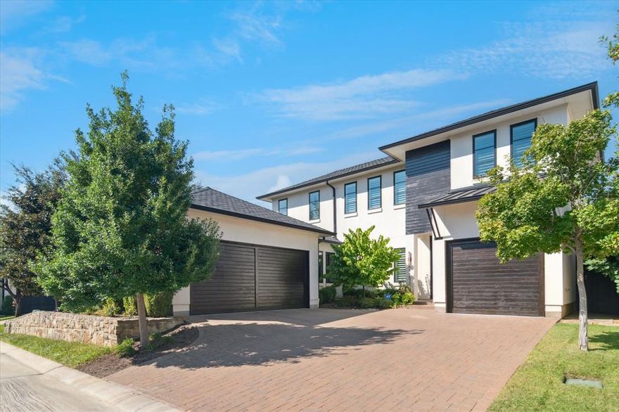 Experience modern living in this contemporary residence, tucked inside one of North Dallas’s few private gated communities. Perfectly situated off Forest Lane between Hillcrest and Preston Road, 11825 Green Knoll Dr. offers sleek architectural lines, a timeless neutral palette, and a thoughtful floor plan that blends beauty with functionality. The inviting, low-maintenance outdoor space is designed for year-round enjoyment with a covered patio, fireplace, motorized retractable screens, and seamless indoor-outdoor flow. Inside, the gourmet chef’s kitchen impresses with dual islands, a Wolf 6-burner gas cooktop, Sub-Zero built-in refrigerator, designer marble countertops, and abundant custom cabinetry. A spacious butler’s pantry expands the possibilities with additional storage, serving space and room for a custom coffee bar. The open-concept living area features a wet bar, wine cooler, beverage fridge and a 2025 nugget ice machine—perfect for entertaining. A flexible formal dining room or office, currently used as a music room, is enhanced with custom sliding privacy doors. The luxurious primary suite overlooks the backyard oasis and includes a spa-inspired bath with a soaking tub, expansive shower, and dual vanities. A second ensuite bedroom downstairs provides comfort for guests, while two additional upstairs bedrooms with ensuites flank a large game room for versatile living. Notable upgrades include: whole-home generator, plantation shutters and professionally designed $100,000 AV system with Sonos multi-zone audio, ceiling speakers, dual TV feeds, security cameras, backup time-controlled interior lights, and high-performance internet firewall. All just minutes from NorthPark Center, The Galleria, and Dallas’s top private schools, this residence delivers the perfect blend of lifestyle, location, and community.