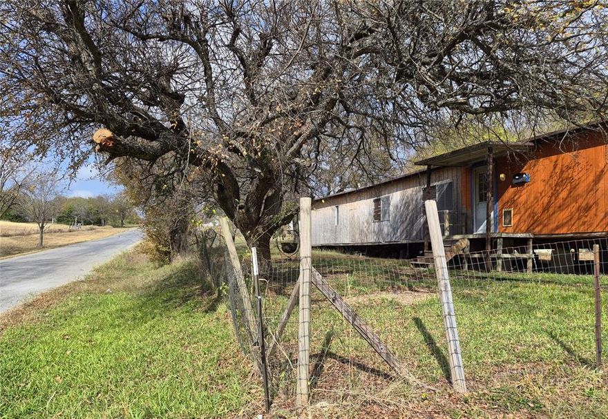 LAND!! Enjoy the tranquility and freedom of country living – 2.989 acres of beautiful, gently rolling prairie in Ellis County’s Palmer Texas. Walk through the secluded and stunningly beautiful trees down back towards the winding creek. Room for livestock, a vegetable garden, even a large garage and 
workshop. TWO water meters. TWO septic systems. Desirable Palmer schools. On Palmer’s school bus route. Outside of the city. No restrictions. No city taxes. No HOA. Listing is for LAND ONLY -- Two manufactured homes: 2-1 and 2-2, needing full renovation will convey with bills of sale. Could be 
used for multifamily home site, as rentals, or truly escape -- build a cabin out back. What’s YOUR DREAM?