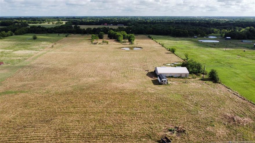 Discover the endless possibilities with this beautiful 14.78-acre property, made up of two parcels, located in highly sought-after Lone Oak ISD, just minutes from Lake Tawakoni. Whether you're dreaming of building your forever home, establishing a farm, or creating space for multiple residences, this property offers it all. At the heart of the land sits a spacious 40x60 shop with electricity and water available, perfect for projects, storage, or agricultural use. A sewer and water taps are also available, providing added convenience for future development. Toward the back of the property, enjoy a private pond that is ideal for fishing, watering cattle, or simply unwinding by the water's edge. You'll fall in love with the peaceful surroundings, wide-open spaces, and the breathtaking sunrises and sunsets that stretch across the sky. Don’t miss this rare opportunity to own acreage with so much potential in a prime location.
