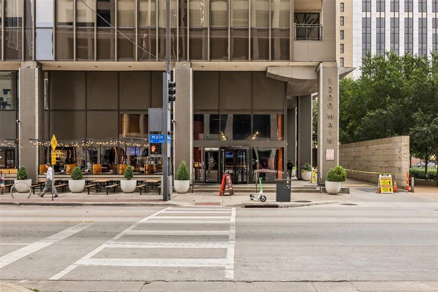 Experience the best of upscale city living in this stylish 5th-floor condominium, where modern design meets impressive Dallas skyline views. From the moment you arrive, a 24-hour concierge and security team provide comfort and peace of mind. The contemporary kitchen flows seamlessly into the spacious living area, highlighted by an oversized island perfect for casual dining or entertaining. In the living room, a sliding glass door opens to a covered balcony with views of downtown, while the primary bedroom features a window that frames the city and fills the space with soft natural light.
Life here comes with an enviable list of amenities: a resort-style pool overlooking the city, spa, landscaped green spaces with outdoor grilling stations, fitness center, theater, art and craft studio, boardroom-style workspace, storage areas, community lounge, guest accommodations, laundry and package services, and secure gated parking with your assigned space included. Just outside the building, you’re steps from parks, fountains, the vibrant AT&T Discovery District, boutique shopping, dining, coffee shops, fitness studios, historic landmarks, museums, and entertainment venues. Whether you want to immerse yourself in downtown’s energy or relax in your private retreat, this home offers the perfect balance. Schedule your tour and experience Dallas living from a whole new perspective.