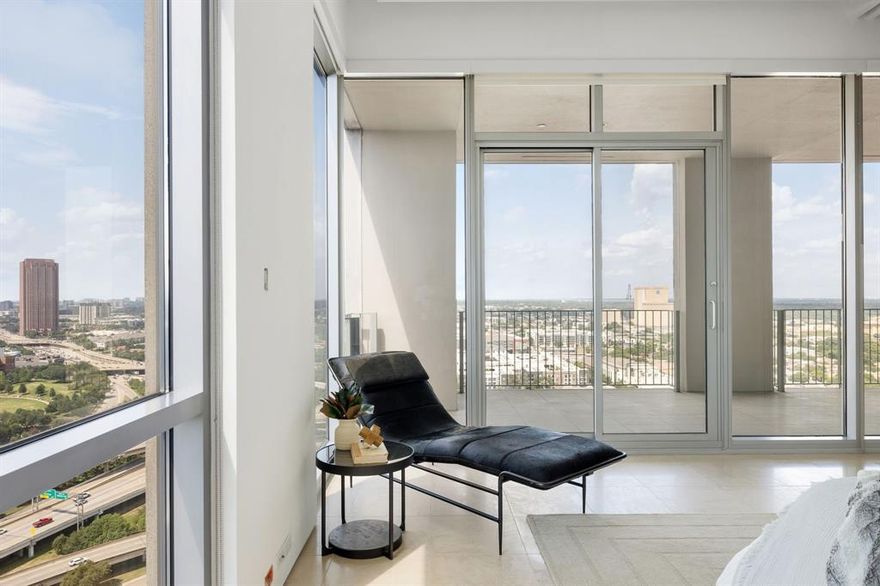 Timeless & masterfully modern—this rare corner residence at One Arts embodies the reason Lionel Morrison’s work endures. With ceilings that stretch 11 feet high and museum-finish walls calling for private art collections to define the space, this floorplan is found on only two levels of the building, where windows wrap around two sides, pulling in soft light and panoramic views of Uptown and East Dallas. The layout is thoughtful and clean, anchored by a 457-square-foot covered terrace that runs the entire length of the home. Three sliding glass doors merge indoors and out, seamlessly connecting the main living areas to the sunrise views and beyond. Limestone flooring grounds the space, while a Bulthaup kitchen—fitted with Miele appliances, a SubZero fridge and classic Carrara marble—makes for stunning minimalist function. The primary suite is equally as impressive, with an upgraded bathroom featuring large-format porcelain tile, soaking tub and a separate walk-in shower. The closet is large and was custom-designed to optimize space, storage and function. Designer grasscloth wallpaper adds just enough edge without overwhelming the clean lines of the architecture. Additionally, details like reveal linear HVAC vents and shadow gap baseboards speak to the skill and craftsmanship imbedded in its design. Residents of One Arts enjoy concierge service, valet parking, a rooftop pool and fitness room—all perched above Dallas’ Arts District, just a stroll from Klyde Warren Park, world-class museums, music venues and dining.