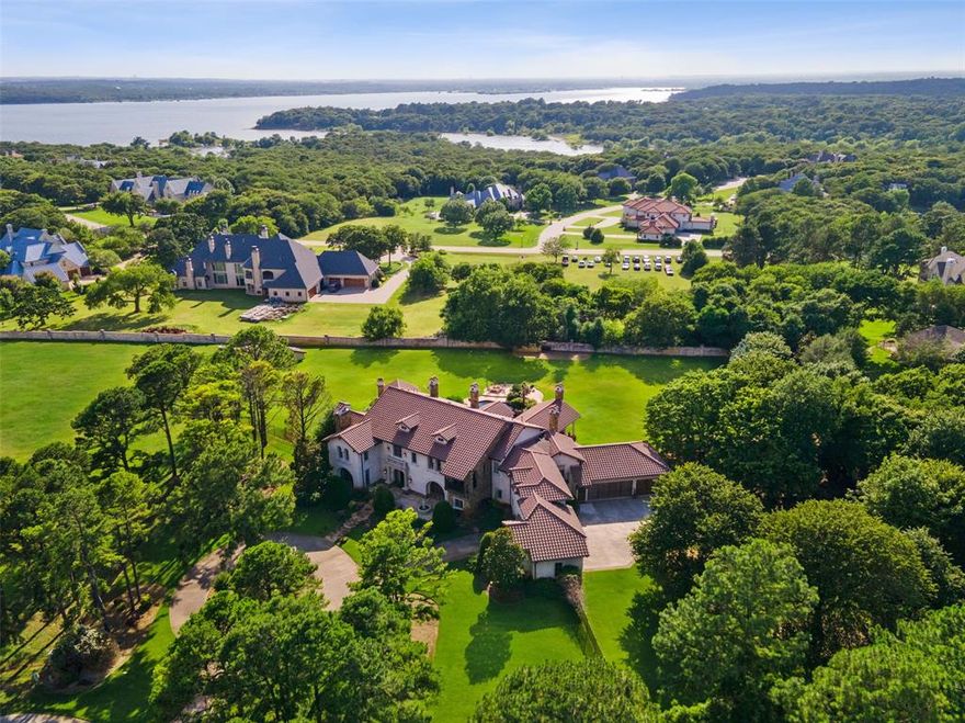 An extraordinary estate located in the exclusive guard gated community of Chateau Du Lac! Nestled on a sprawling 2 acre lot, canvassed by mature trees, highlighted by lush landscaping & completely private! Inside boasts charm & character throughout! Grand & dramatic entry, generous bedroom suites, Master w-spa bath + exercise room. Numerous fireplaces, 1st floor media w-bar, game room, charming living spaces, wooden beamed ceilings + Formals. Top of the line Chef's Kitchen! Inside flows seamlessly to the outdoor paradise, creating a lifestyle of ease & leisure. Relax in the pool or by the outdoor FP. This estate offers abundant space for enjoying a chic, sophisticated lifestyle that is unmatched for this area.