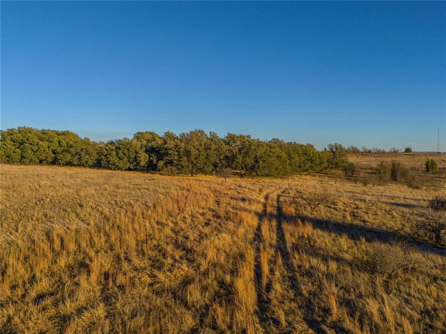 This 8.1-acre property is located in the gated Mercers Preserve community in Comanche County, Texas. The tract features gently rolling terrain with elevated views of Lake Comanche and the surrounding countryside. Numerous large, mature live oak trees are scattered throughout the property.

The property offers paved road access and is located approximately 5.2 miles south of Comanche, TX, with convenient access to Austin, Fort Worth, Waco and Abilene, as well as, local amenities, dining, shopping, and services. 

Quiet surroundings and the presence of native wildlife contribute to the appeal and tranquil setting of the property. This beautiful tract has multiple potential build sites for your future dream home.