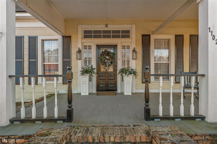 Situated on a prominent corner lot of approximately 2 acres within the city limits of Minden, this unique property offers an exceptional opportunity for both residential and commercial buyers. Grandfathered as residential yet zoned commercial, it provides flexibility, visibility, and high-traffic exposure along a well-traveled corridor.

The home welcomes you with a charming front porch and an inviting entry that opens into a spacious living area featuring a gas log fireplace. Inside, you’ll find 10-foot ceilings, large double-pane windows that flood the home with natural light, and original hardwood floors that have been recently refinished. Notable updates include new sheetrock, fresh interior paint, a new roof, central heating, and electrical upgrades, blending historic character with modern improvements.

The kitchen is thoughtfully updated with quartz countertops and under-cabinet lighting, adding both function and charm. One of the home’s most distinctive features is a second front entrance, often referred to as a “traveler’s door,” which opens directly into the front bedroom. Historically, this allowed the space to be separated and used independently, adding to the property’s versatility.

Outside, the expansive yard is dotted with mature pecan trees, offering a peaceful setting rarely found in such a visible and accessible location.

Whether you envision this as a private residence, office space, boutique business, or a combination of both, the possibilities are truly endless. With its prime location, generous acreage, and flexible zoning, this property presents a rare opportunity to live, work, or invest in the heart of Minden.