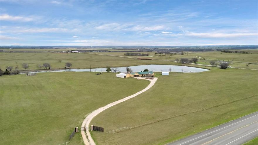 Don't miss this incredible opportunity! This prime 34-acre property, offers tremendous potential for developers and investors looking to capitalize on the expansion of DFW. create a recreational destination of your own, or enjoy it all for yourself. Enjoy the best of both worlds…while enjoying your peaceful retreat,  you are Less than an hour from Dallas-Fort Worth & Just 35 minutes from Waco, this property has easy access to I-35, Buc-ee’s, groceries, and downtown Hillsbor. t’s an unbeatable location for solitude AND convenience. There’s a picturesque and mature, 7-acre stocked pond with a dock perfect for fishing or paddle boating. It’s also an ideal centerpiece for any future development. There is a unique 1,435-square-foot, 2-bedroom, 3-bath home, already equipped with a GENERATOR, and TONS of historical character. The home was designed with reclaimed wood and doors from classic post offices. There’s a  2-car garage that is 24x30 ft, 2 additional carports, 8x40 ft  storage unit, & storm shelter. This is Rural living at its finest, combined with unbeatable investment potential, no deed restrictions and an incredible location! This property would be an ideal future RV Park, the home could easily be converted for a property caretaker, office, or retail space; Simply, wherever your dreams and imagination can take you! Don’t miss your chance to take advantage of this incredible opportunity. USDA eligible!