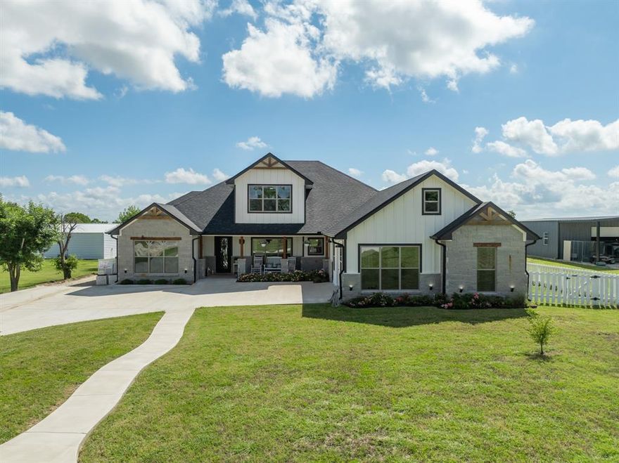 This spacious 5-bedroom, 3.5-bath custom home in Robinson, TX is nestled on 3.4 acres of land and has  another 950 sq ft residence that could be used as an apartment or mother in law home. Designed with efficiency and comfort in mind, the home features two HVAC systems with energy-saving heat pumps, green spray foam insulation, two tankless water heaters, and dual custom stone gas fireplaces—one indoors with a battery backup to ensure heat during power outages.
The heart of the home is the entertainer’s kitchen, which showcases a 50-square-foot island, built-in commercial-grade ovens, a gas cooktop, coffee bar, tile backsplash, granite countertops, and floor-to-ceiling custom cabinetry. Each bathroom throughout the home includes granite surfaces and designer tile showers. The private primary suite on the main floor offers a luxurious escape with a walk-in tiled shower, freestanding tub, oversized closet with built-ins, and dual vanities.
Upstairs features a spacious bonus area, an additional bedroom, a full bathroom, and a large storage closet with built-in shelving.
The former two-car garage has been thoughtfully enclosed and finished with front entry doors, windows, and a mini-split HVAC unit, making it perfect for a home office, gym, or additional living space.
Outdoors, enjoy a covered patio with a gas fireplace and a full outdoor kitchen equipped with a sink, refrigerator, gas grill, and a large granite countertop—ideal for entertaining under the Texas sky. The property also includes a newly built deck, multiple outbuildings, including a chicken coop, 2 sheds, greenhouse, and shed covers for horses or cows.